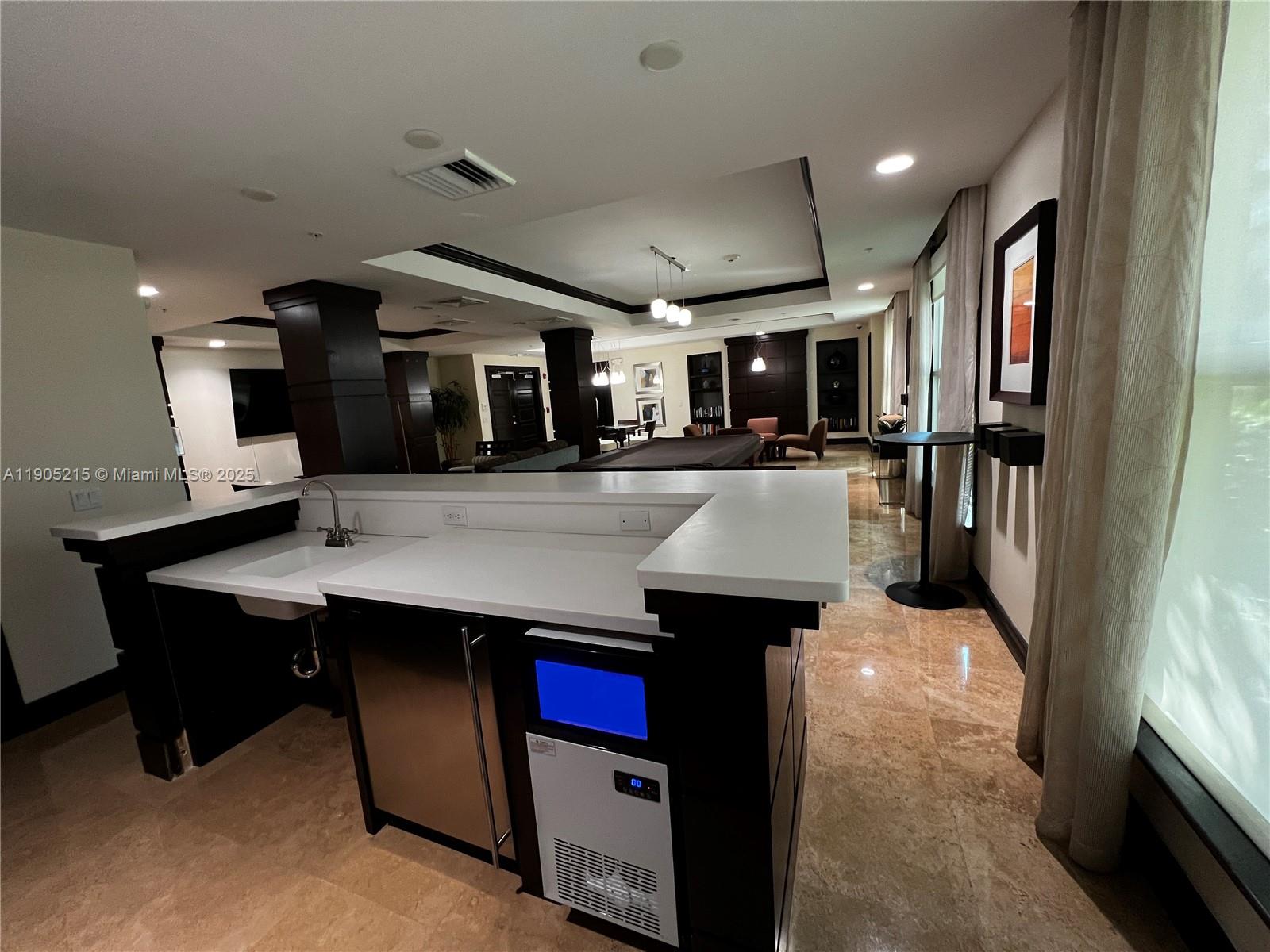 2421 Northeast 65th Street, Unit 506 Fort Lauderdale, FL 33308 - Photo 43 of 59 a kitchen with counter top space cabinets and stainless steel appliances