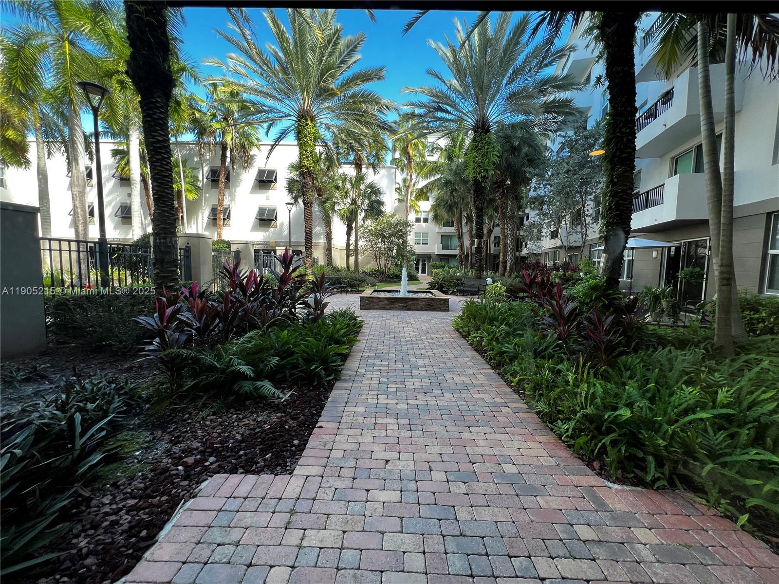 2421 Northeast 65th Street, Unit 506 Fort Lauderdale, FL 33308 - Photo 54 of 59 a view of a pathway with a garden