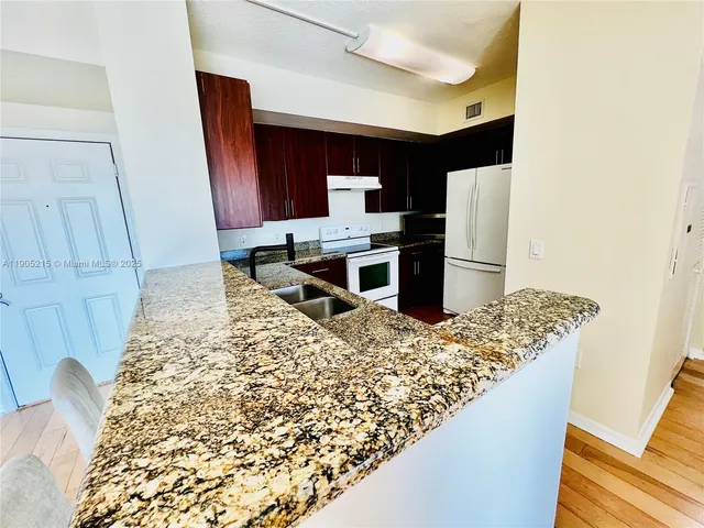 a kitchen with a sink and a refrigerator