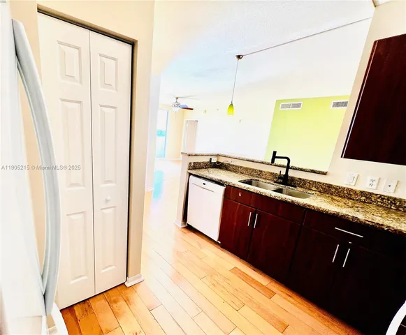 a kitchen with a sink and a refrigerator