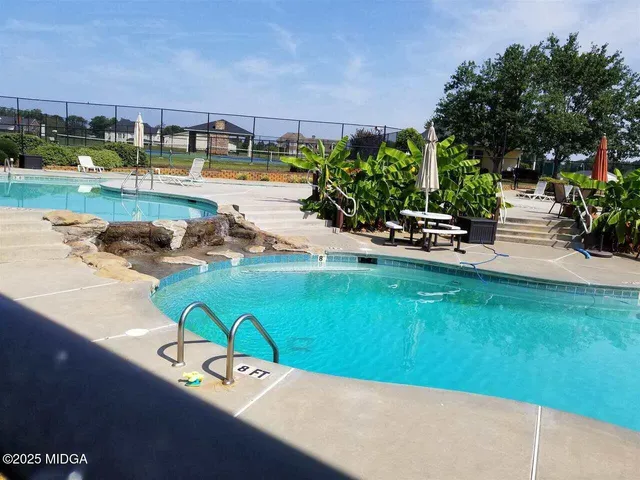 a view of a swimming pool with a yard