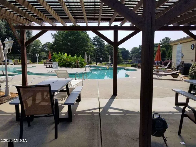 a view of a patio with a table chairs and backyard
