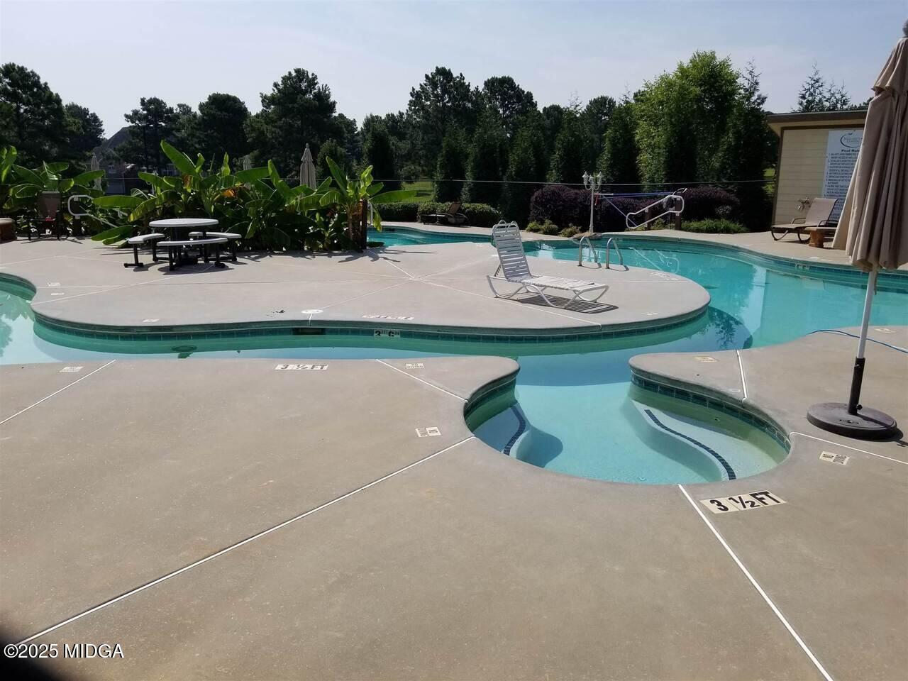 0 Mallard Lane Locust Grove, GA 30248 - Photo 24 of 27 a view of a backyard with swimming pool and sitting area