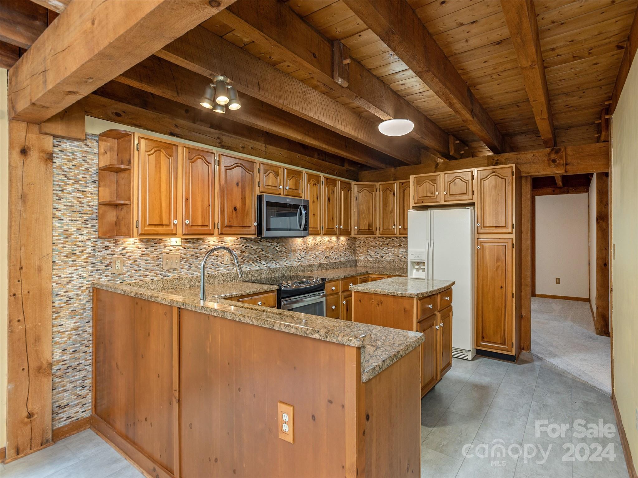 28 Chestnut Ridge Road, Unit 228 Mills River, NC 28759 - Photo 11 of 48 a kitchen with stainless steel appliances granite countertop a sink a stove and a refrigerator