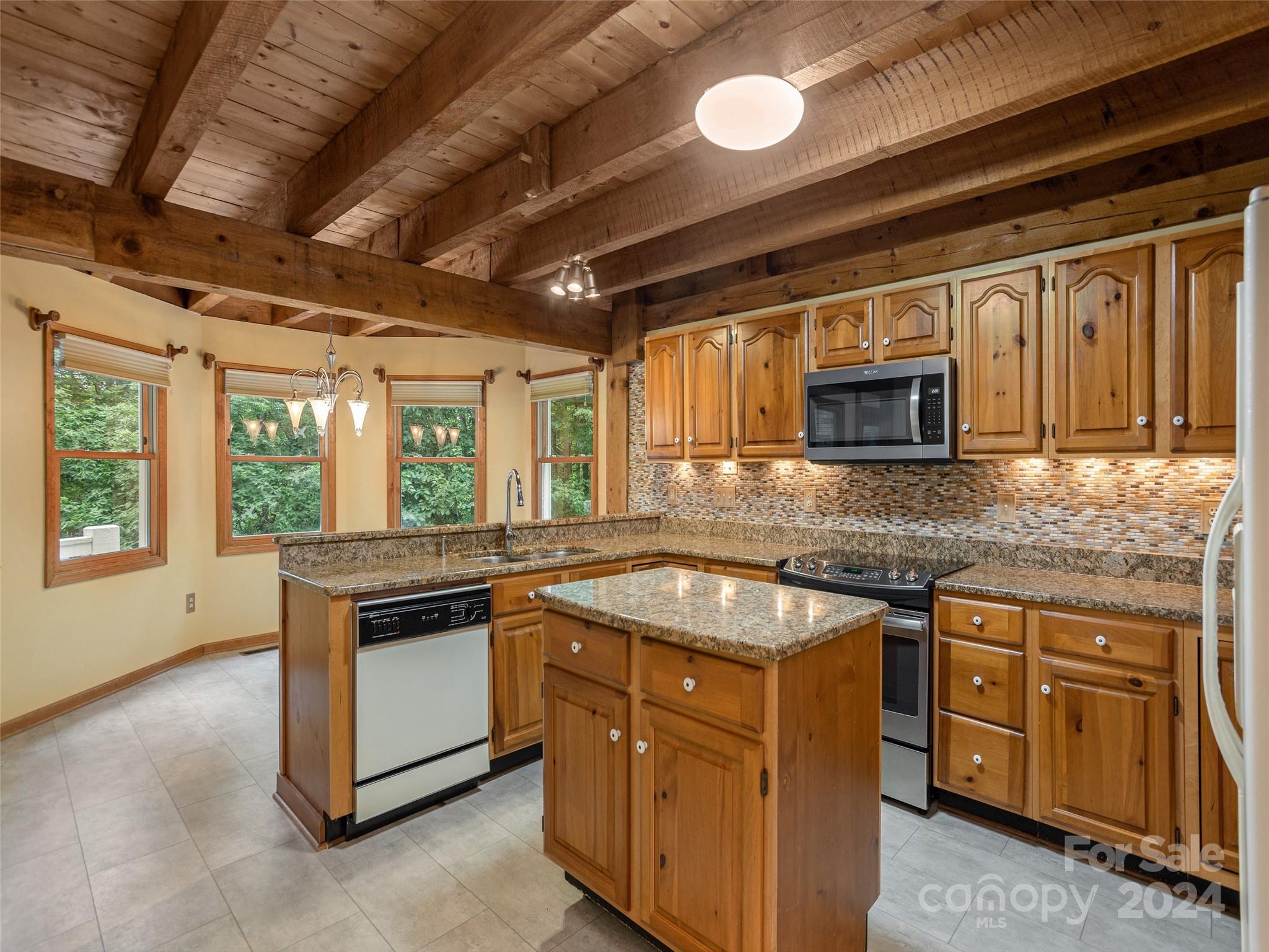 28 Chestnut Ridge Road, Unit 228 Mills River, NC 28759 - Photo 12 of 48 a kitchen with granite countertop a sink stove and microwave