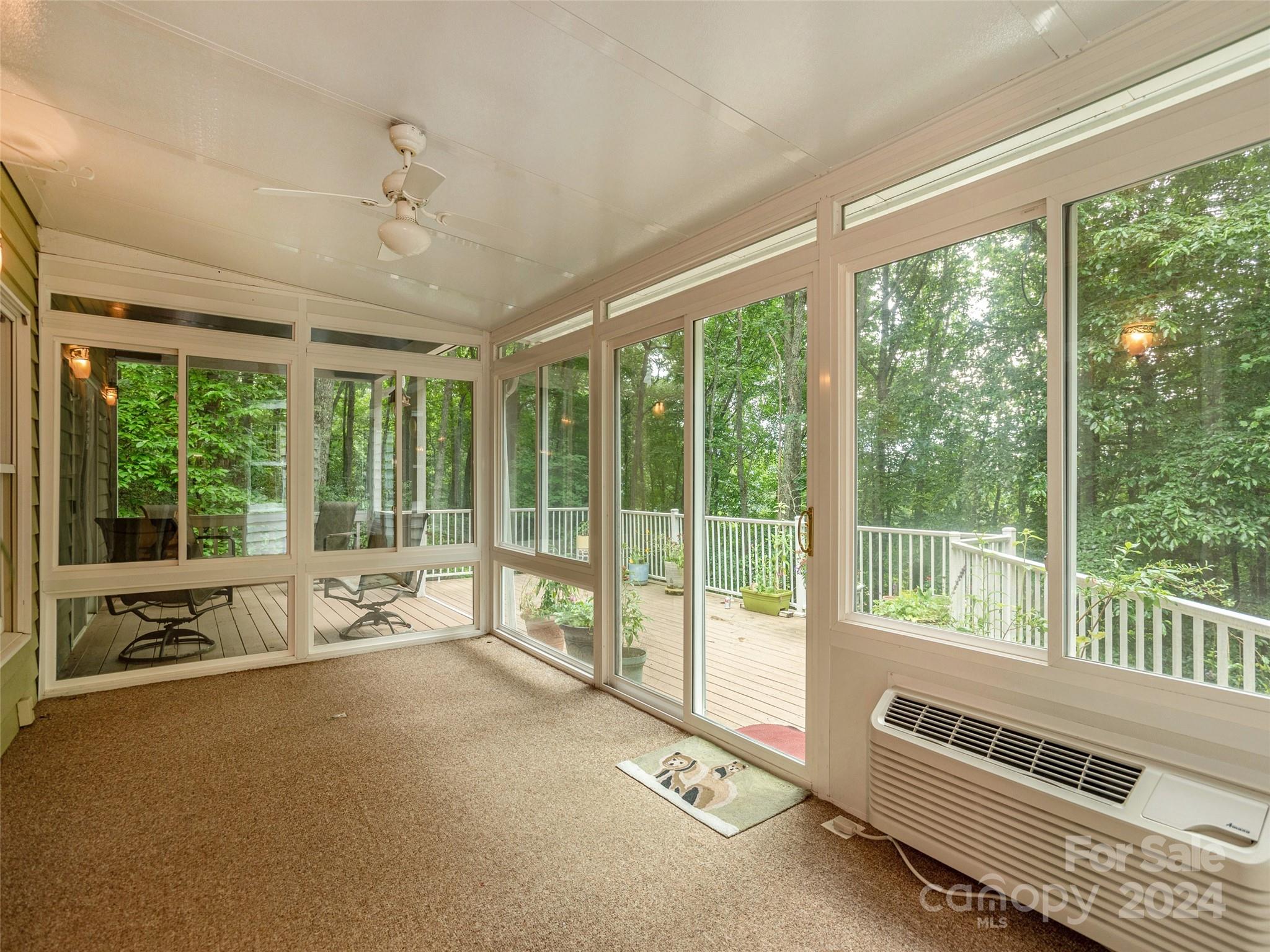 28 Chestnut Ridge Road, Unit 228 Mills River, NC 28759 - Photo 15 of 48 a view of a room with wooden floor and windows