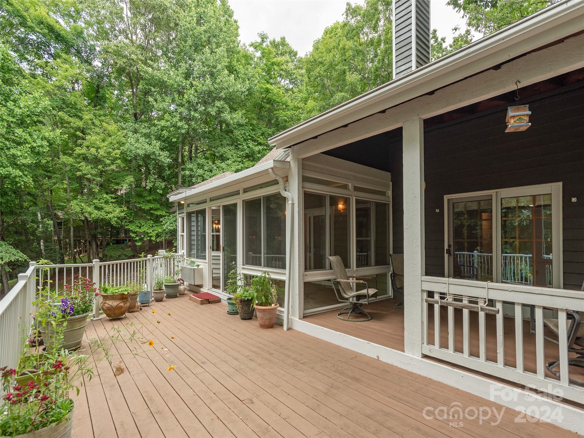 28 Chestnut Ridge Road, Unit 228 Mills River, NC 28759 - Photo 17 of 48 a view of deck with two chair and potted plants