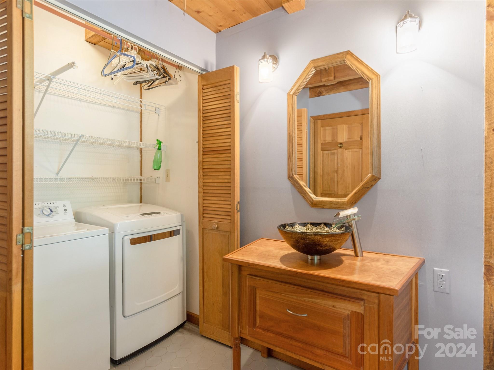 28 Chestnut Ridge Road, Unit 228 Mills River, NC 28759 - Photo 18 of 48 a bathroom with a sink a mirror and a shower