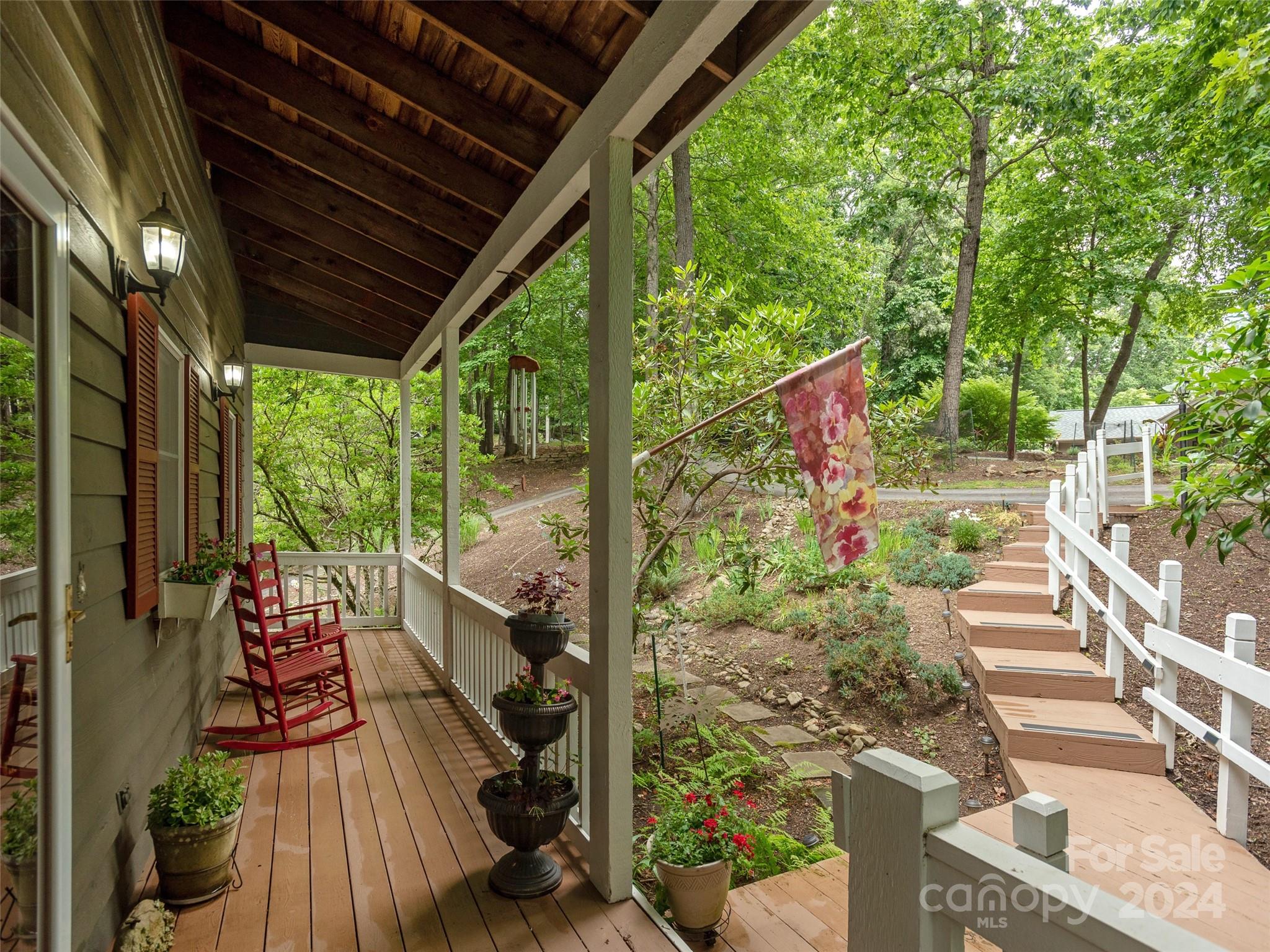 28 Chestnut Ridge Road, Unit 228 Mills River, NC 28759 - Photo 4 of 48 a view of a porch with furniture and garden