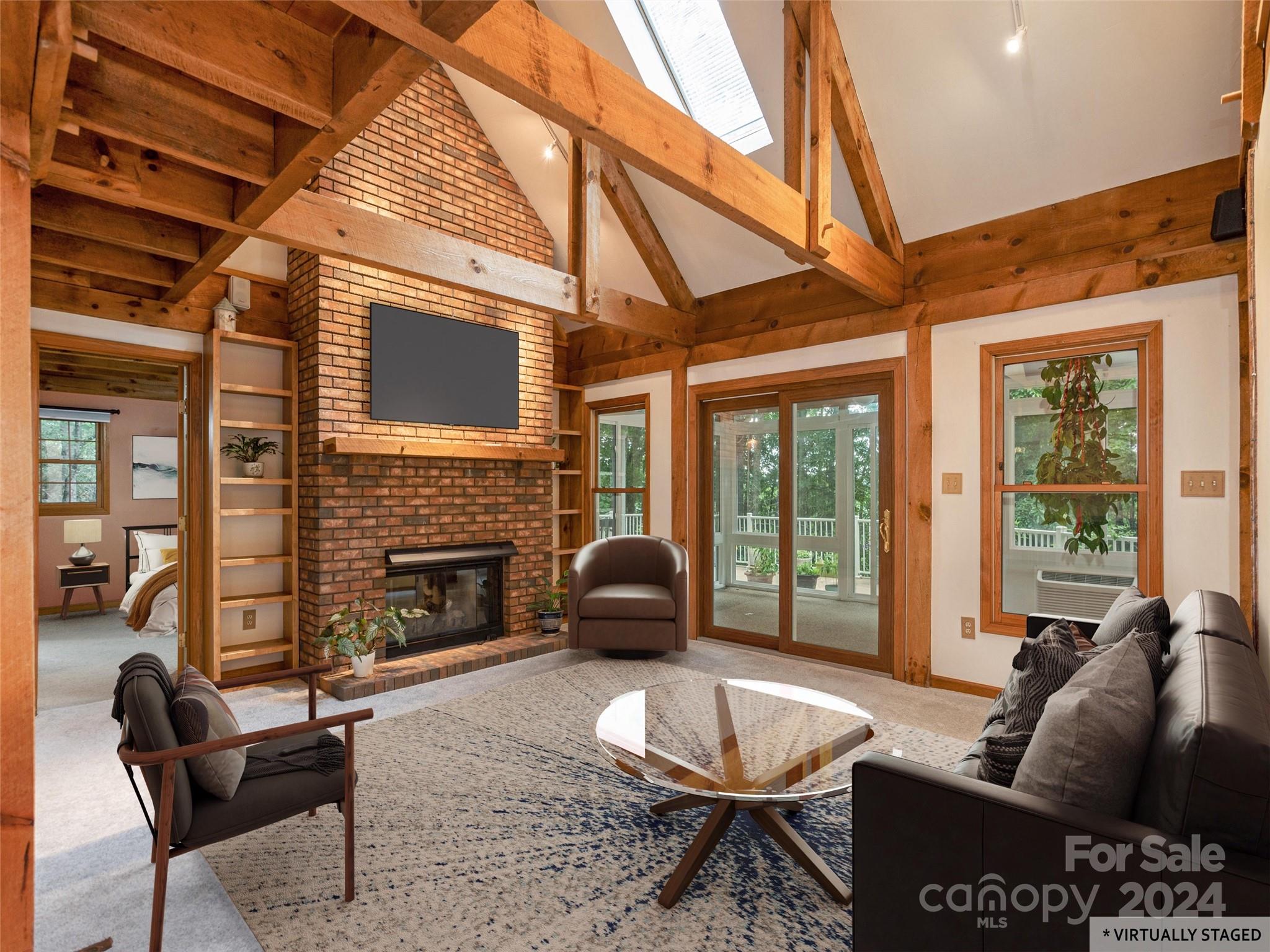 28 Chestnut Ridge Road, Unit 228 Mills River, NC 28759 - Photo 7 of 48 a living room with furniture a fireplace and a large window