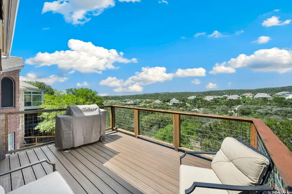 a view of a roof deck with couches and sky view