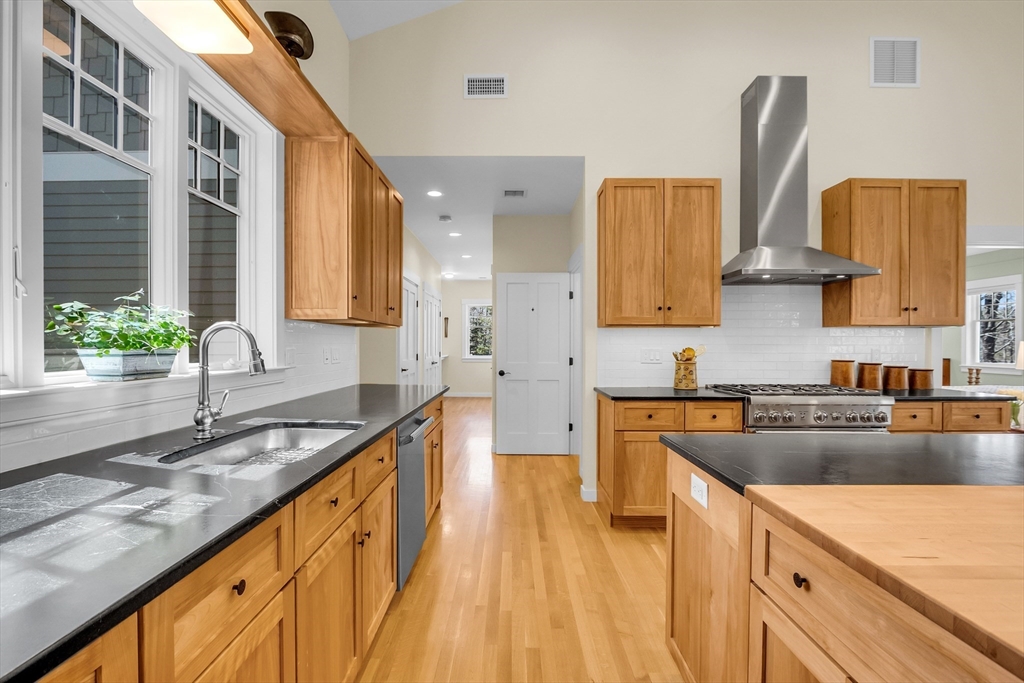 17 Whitney Road Stow, MA 01775 - Photo 11 of 42 a kitchen with stainless steel appliances granite countertop a sink stove and refrigerator