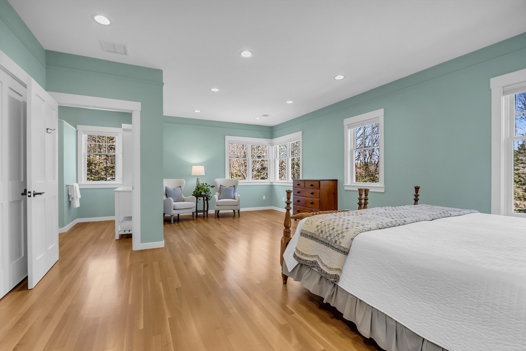 17 Whitney Road Stow, MA 01775 - Photo 20 of 42 a spacious bedroom with a bed and wooden floor