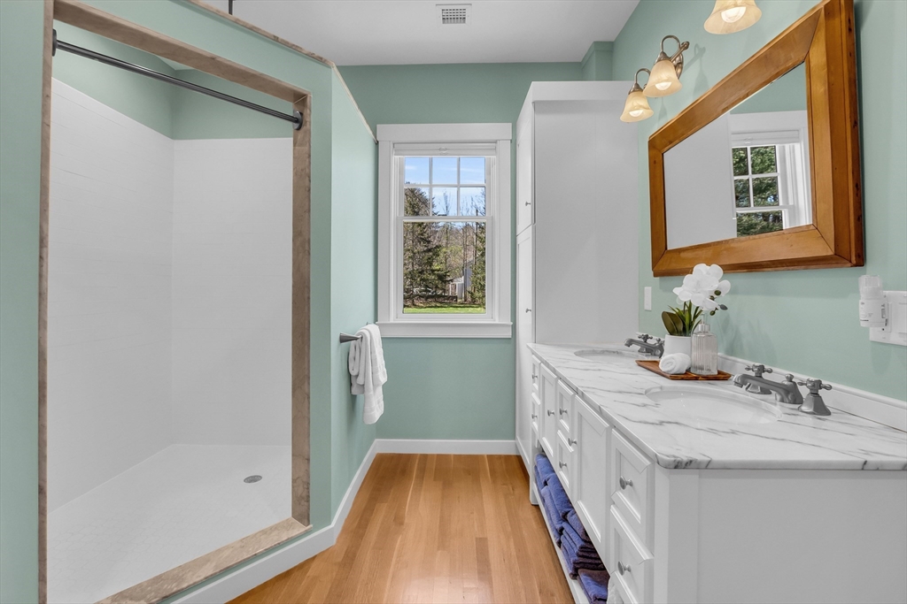 17 Whitney Road Stow, MA 01775 - Photo 22 of 42 a bathroom with a sink a mirror and a bathtub