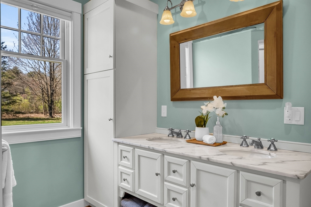 17 Whitney Road Stow, MA 01775 - Photo 23 of 42 a bathroom with a granite countertop sink vanity and mirror