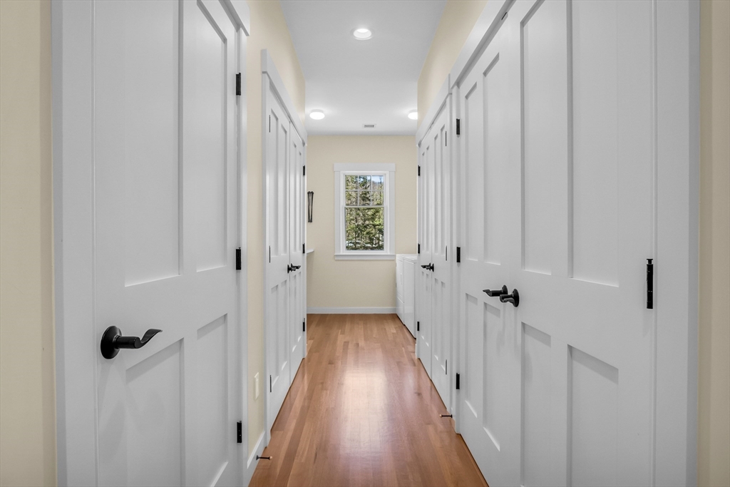 17 Whitney Road Stow, MA 01775 - Photo 31 of 42 a view of a hallway with wooden floor and closet area