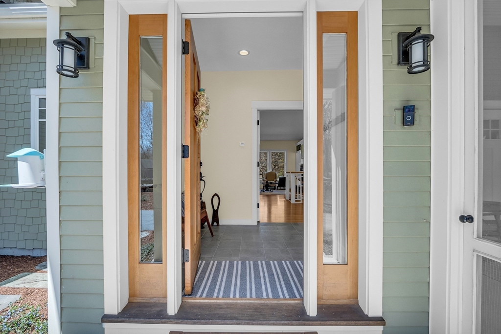 17 Whitney Road Stow, MA 01775 - Photo 5 of 42 a view of a hallway with wooden floor and living room