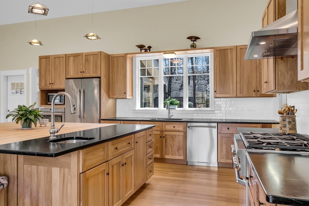17 Whitney Road Stow, MA 01775 - Photo 7 of 42 a kitchen with stainless steel appliances granite countertop a sink stove and refrigerator