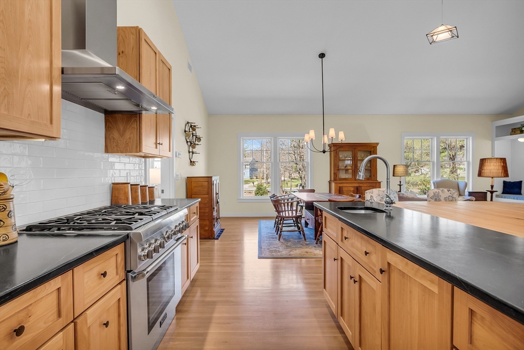 17 Whitney Road Stow, MA 01775 - Photo 8 of 42 a kitchen with stainless steel appliances granite countertop a stove a sink dishwasher and cabinets with wooden floor