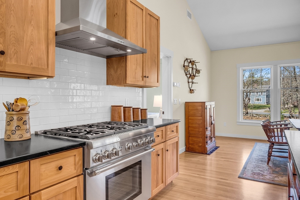 17 Whitney Road Stow, MA 01775 - Photo 9 of 42 a kitchen with granite countertop a stove and a wooden cabinets