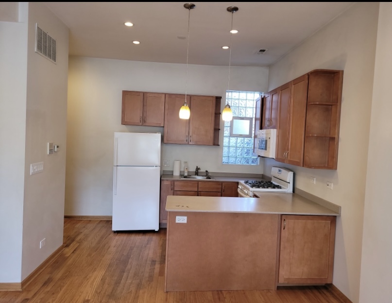 2350 West Grand Avenue Chicago, IL 60612 - Photo 2 of 8 a kitchen with stainless steel appliances granite countertop a sink a refrigerator and a stove