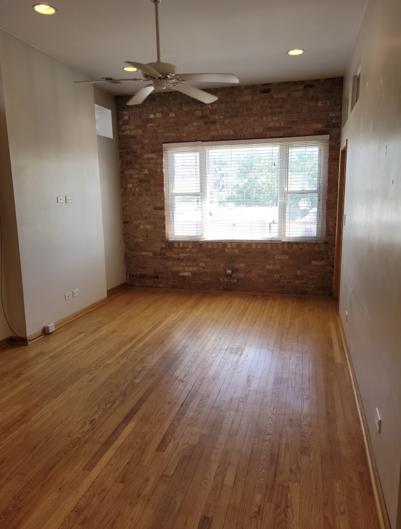 2350 West Grand Avenue Chicago, IL 60612 - Photo 8 of 8 an empty room with wooden floor and windows