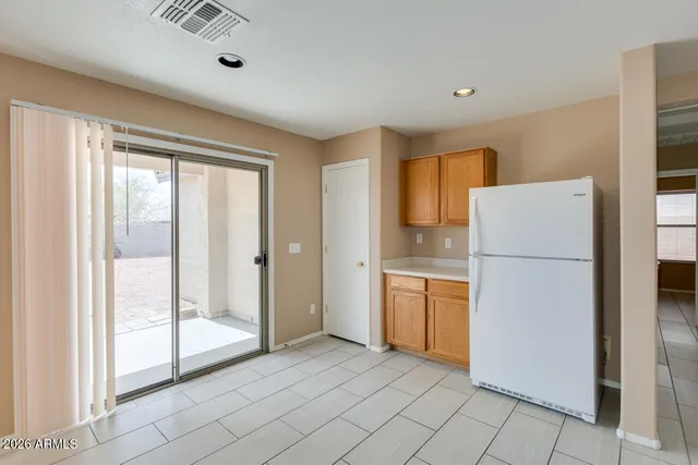 a kitchen with a refrigerator a sink and cabinets