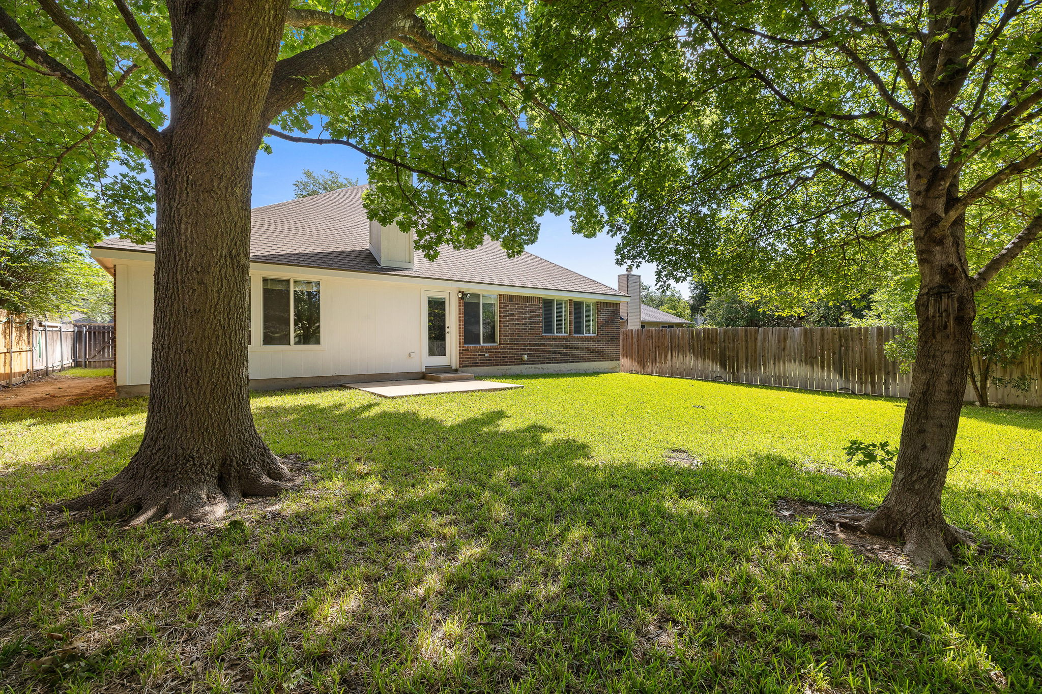 1102 Nelson Ranch Road Cedar Park, TX 78613 - Photo 32 of 37 A verdant backyard retreat offers ample space for recreation, complemented by mature shade trees.