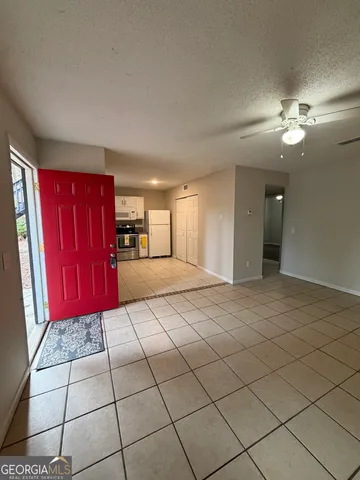 a view of a livingroom with furniture chandelier and windows