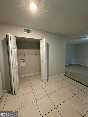a large kitchen with cabinets and stainless steel appliances