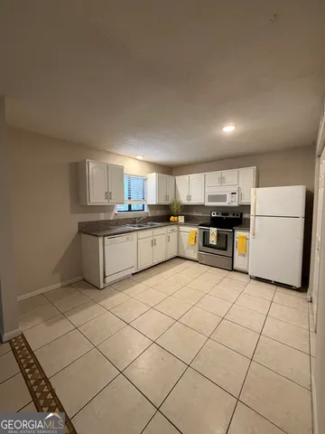 a kitchen with a stove top oven sink and cabinets