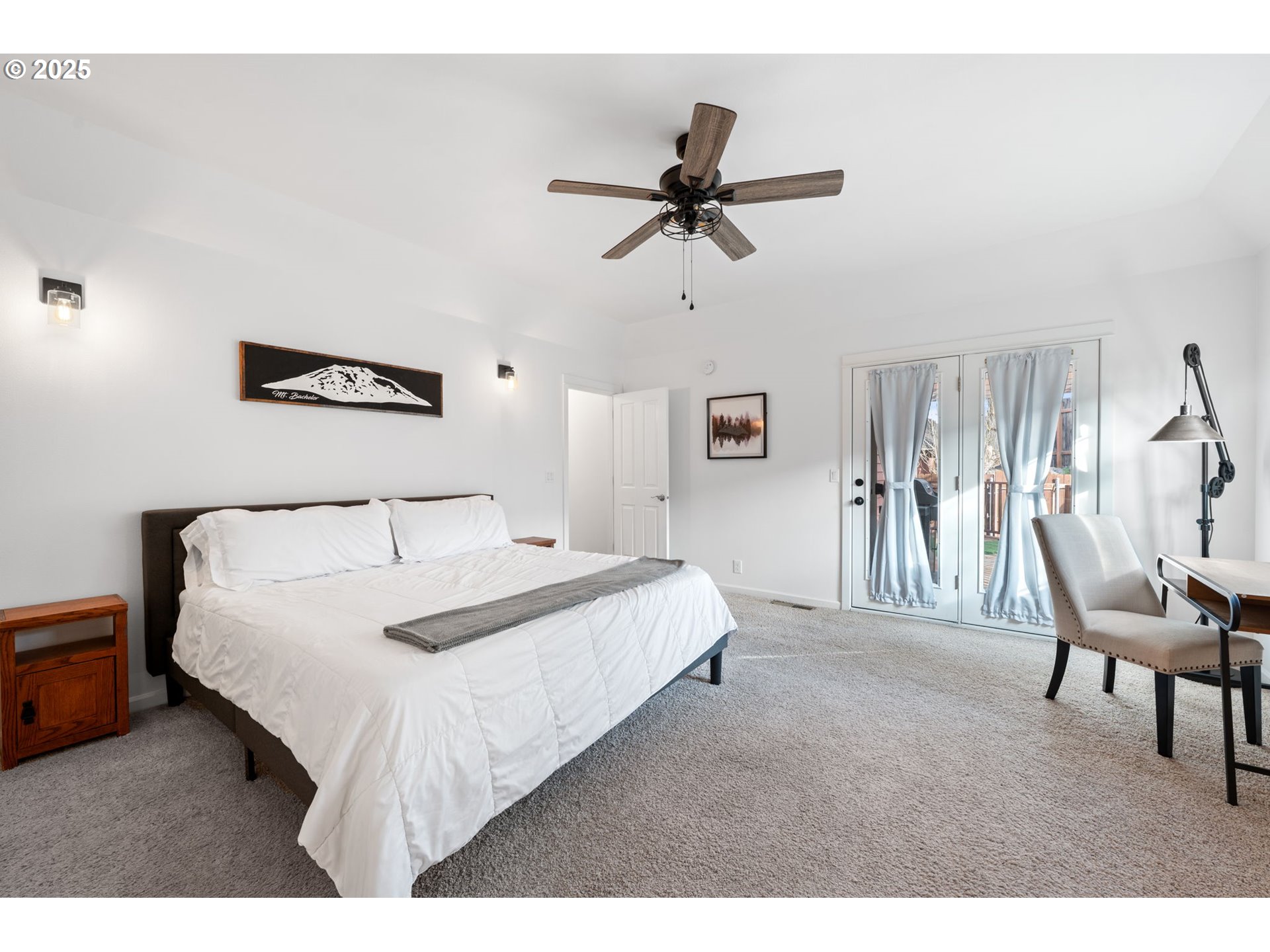 63103 Watercress Way Bend, OR 97701 - Photo 12 of 47 a bedroom with a bed and a chandelier