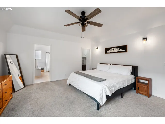a bedroom with a bed and a ceiling fan