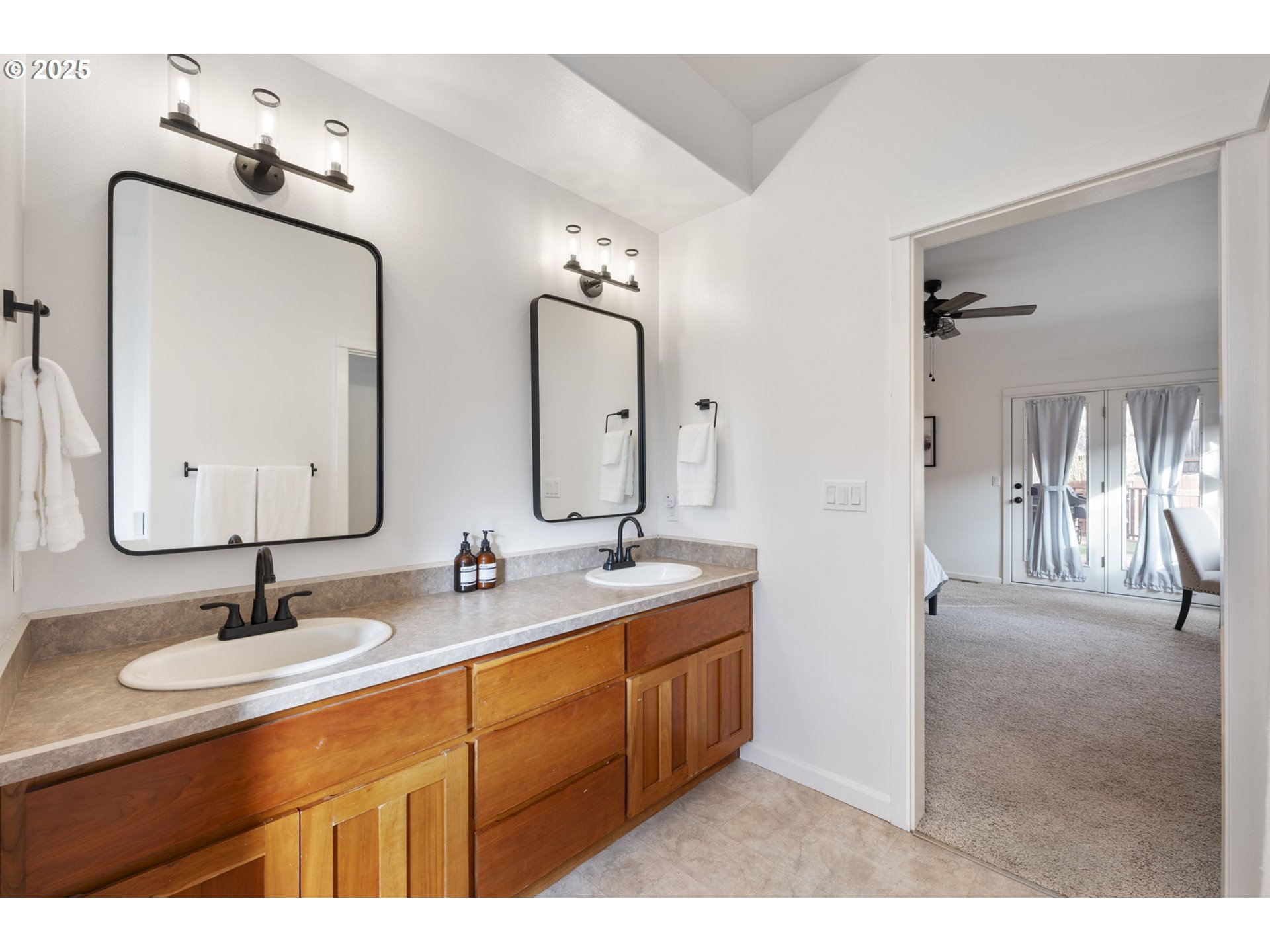 63103 Watercress Way Bend, OR 97701 - Photo 18 of 47 a bathroom with double vanity sinks and a mirror