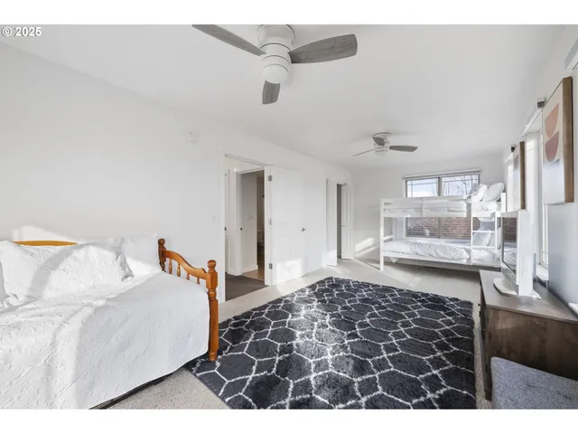 a bedroom with a bed and glass door
