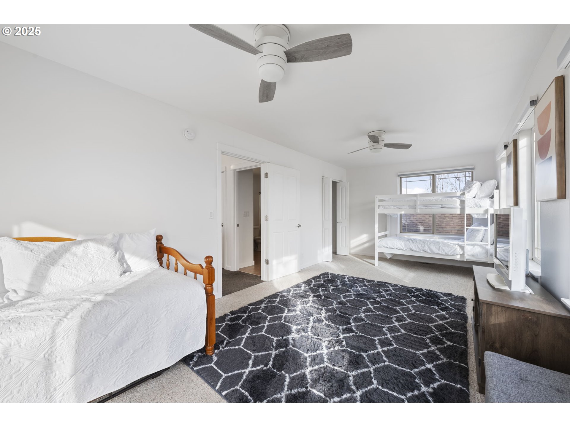 63103 Watercress Way Bend, OR 97701 - Photo 27 of 47 a bedroom with a bed and glass door