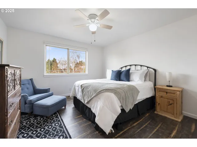 a bedroom with a bed rug and window