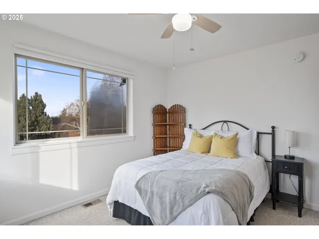 a bedroom with a large bed and a window