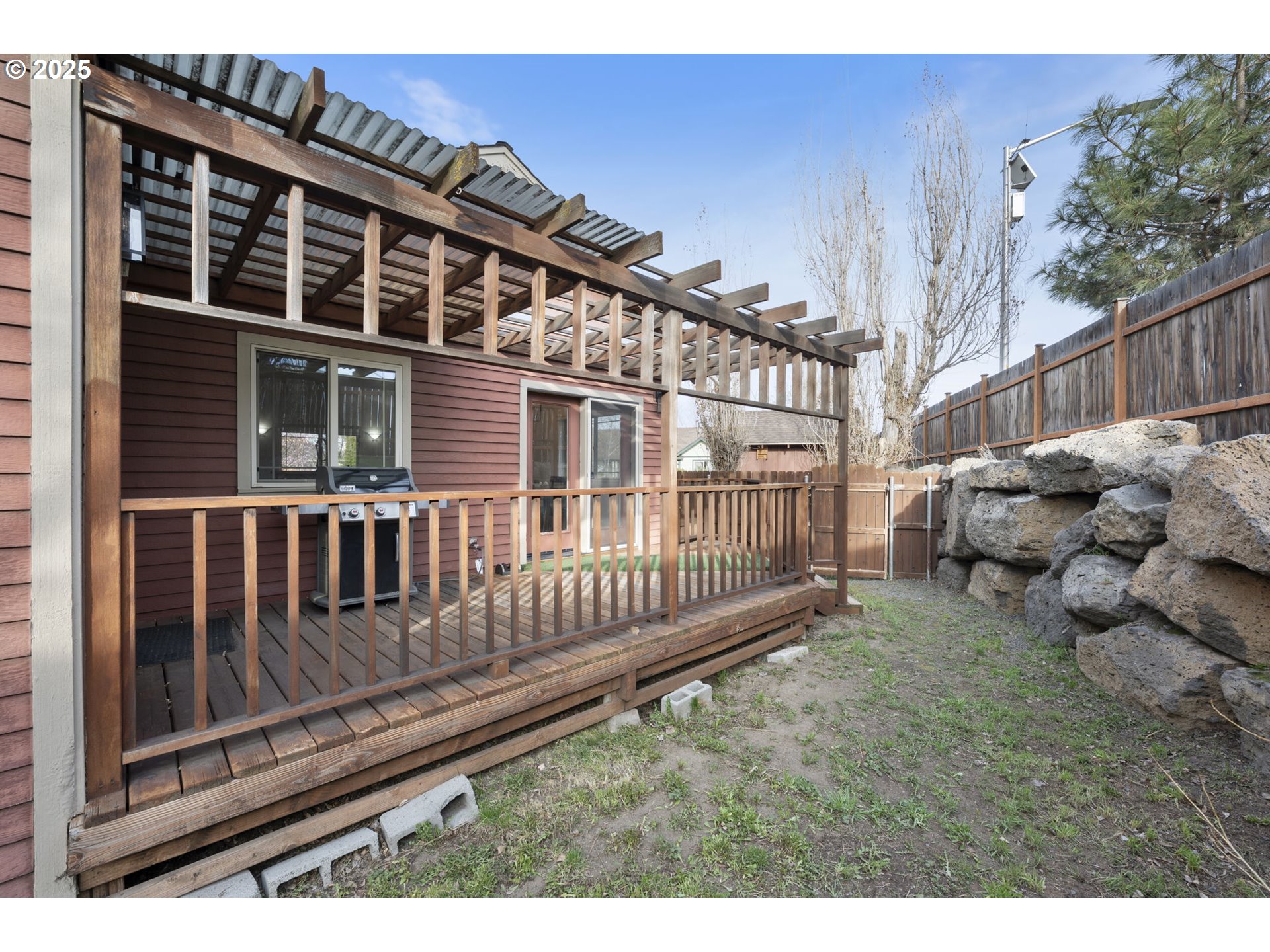 63103 Watercress Way Bend, OR 97701 - Photo 39 of 47 a view of a house with a small yard and wooden fence