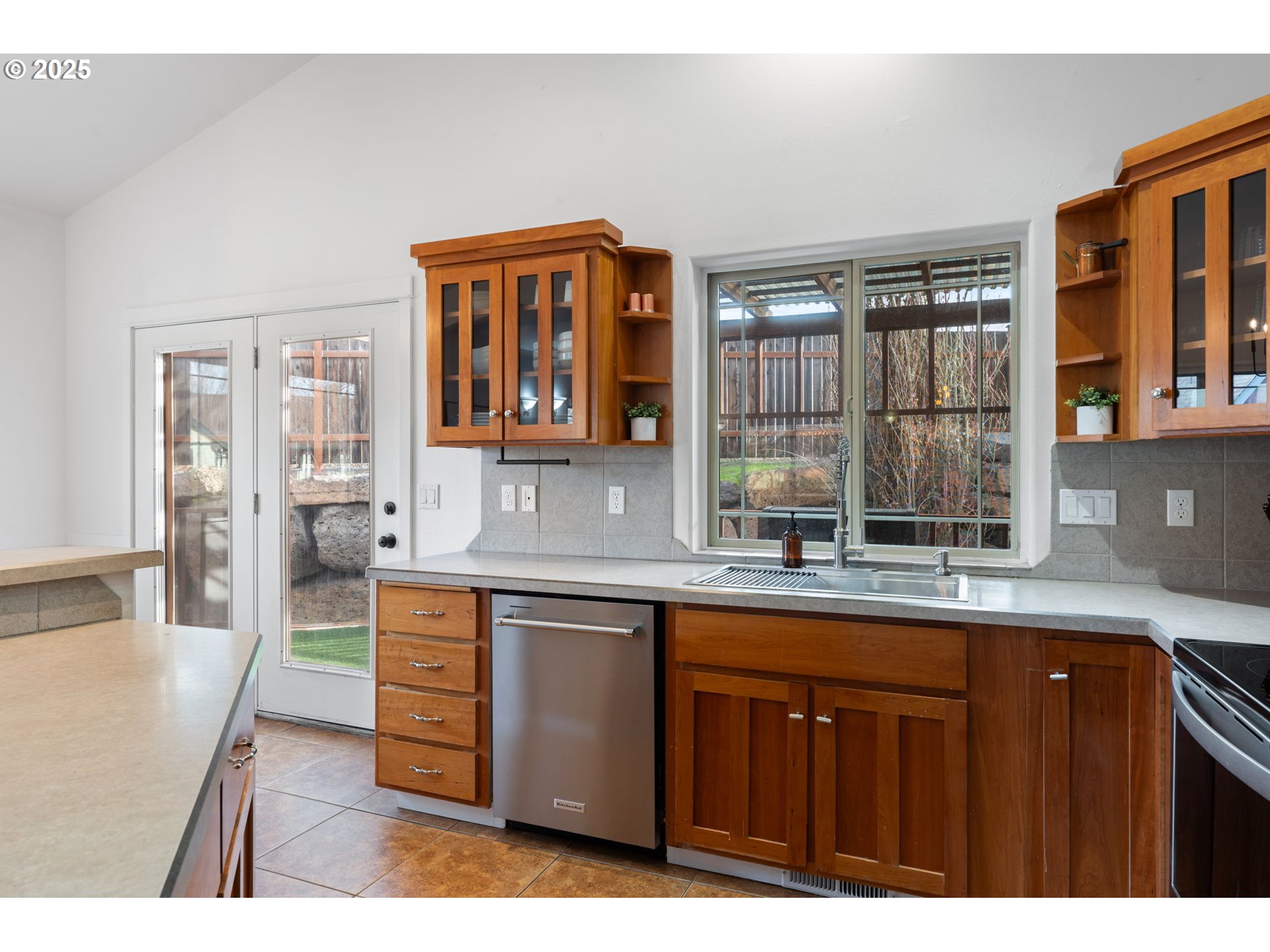 63103 Watercress Way Bend, OR 97701 - Photo 10 of 47 a open kitchen with granite countertop a sink dishwasher stove and wooden cabinets