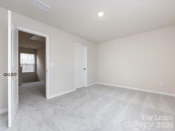 an empty room with mirror in closet