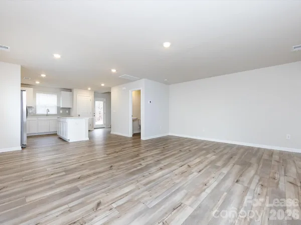a view of kitchen with kitchen island sink and wooden floor