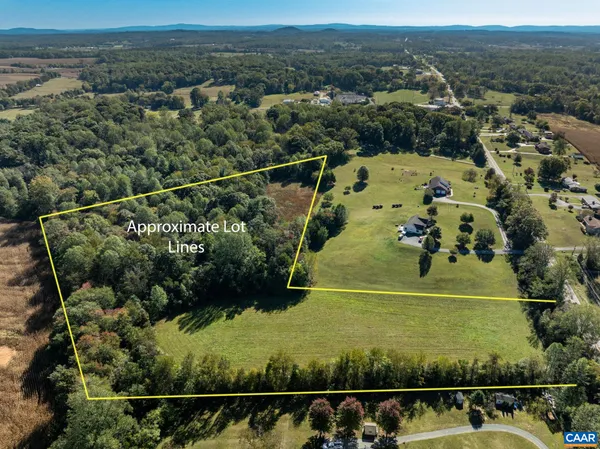 an aerial view of lake residential house with swimming pool