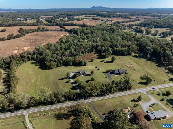 an aerial view of a residential houses with outdoor space