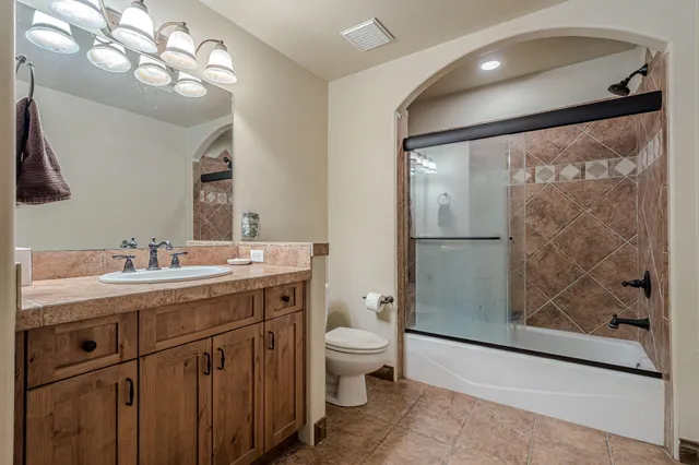 a spacious bathroom with a toilet sink and a mirror
