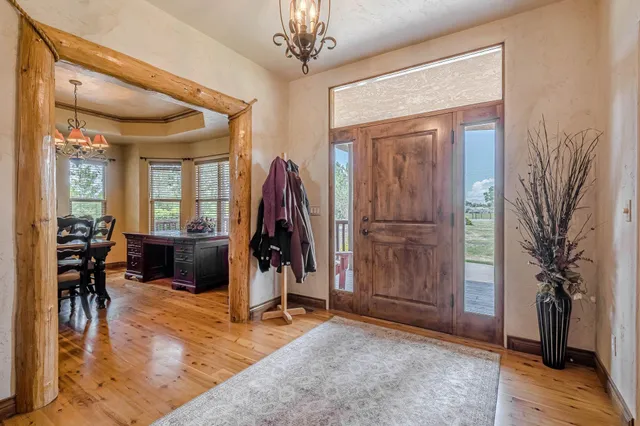 a view of a livingroom with furniture and hardwood floor