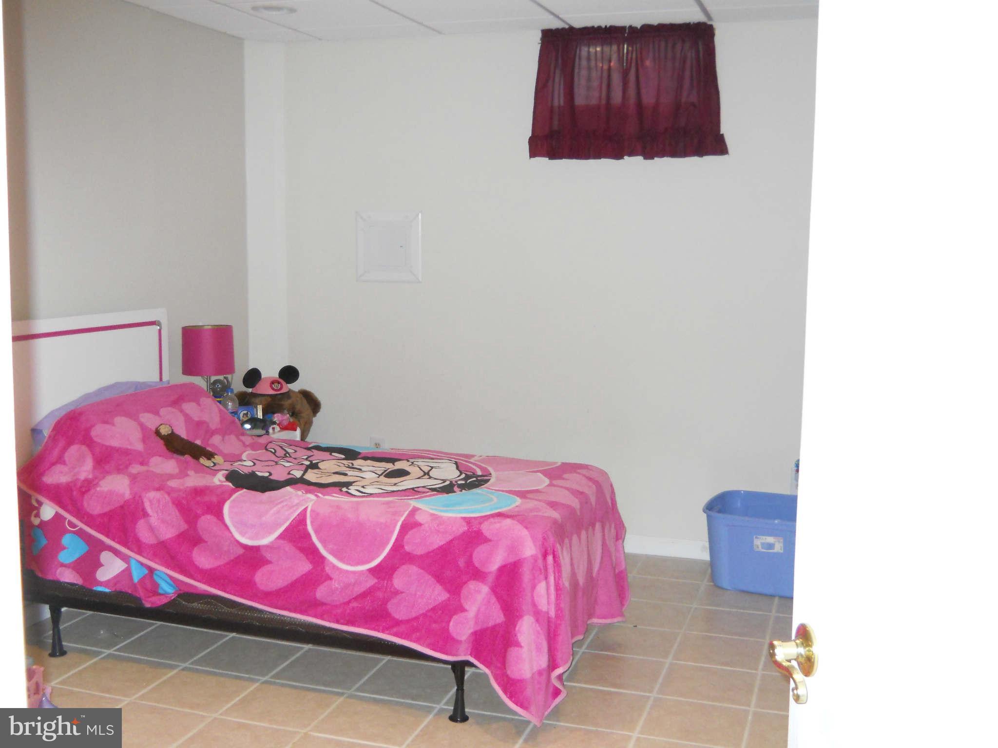 227 Hitching Post Drive Rising Sun, MD 21911 - Photo 11 of 26 a bedroom with a bed and a wall painting