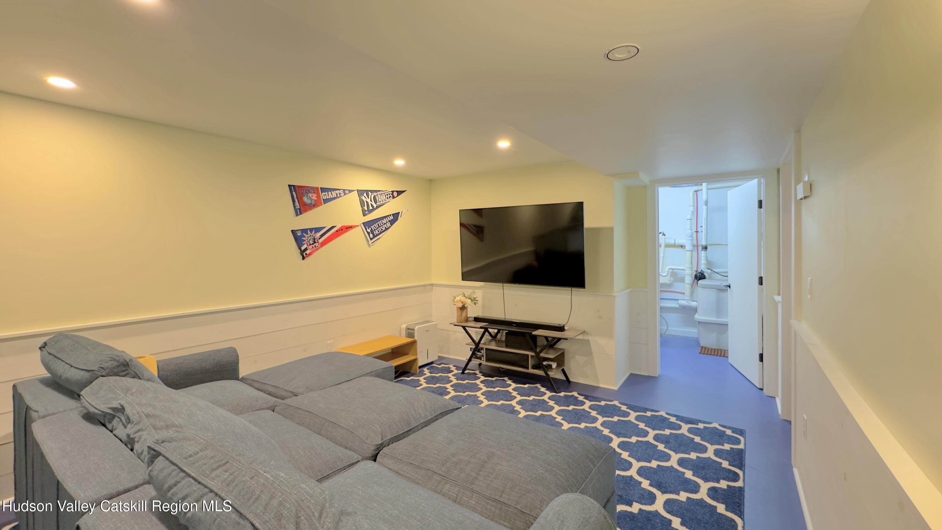 3223 Sleepy Hollow Road Athens, NY 12015 - Photo 18 of 55 a bedroom with a bed and a flat screen tv