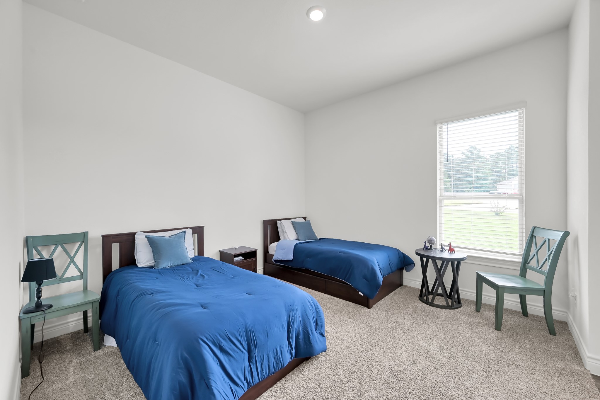 12250 Seagrape Lane Conroe, TX 77304 - Photo 18 of 19 a bedroom with two beds and a chair