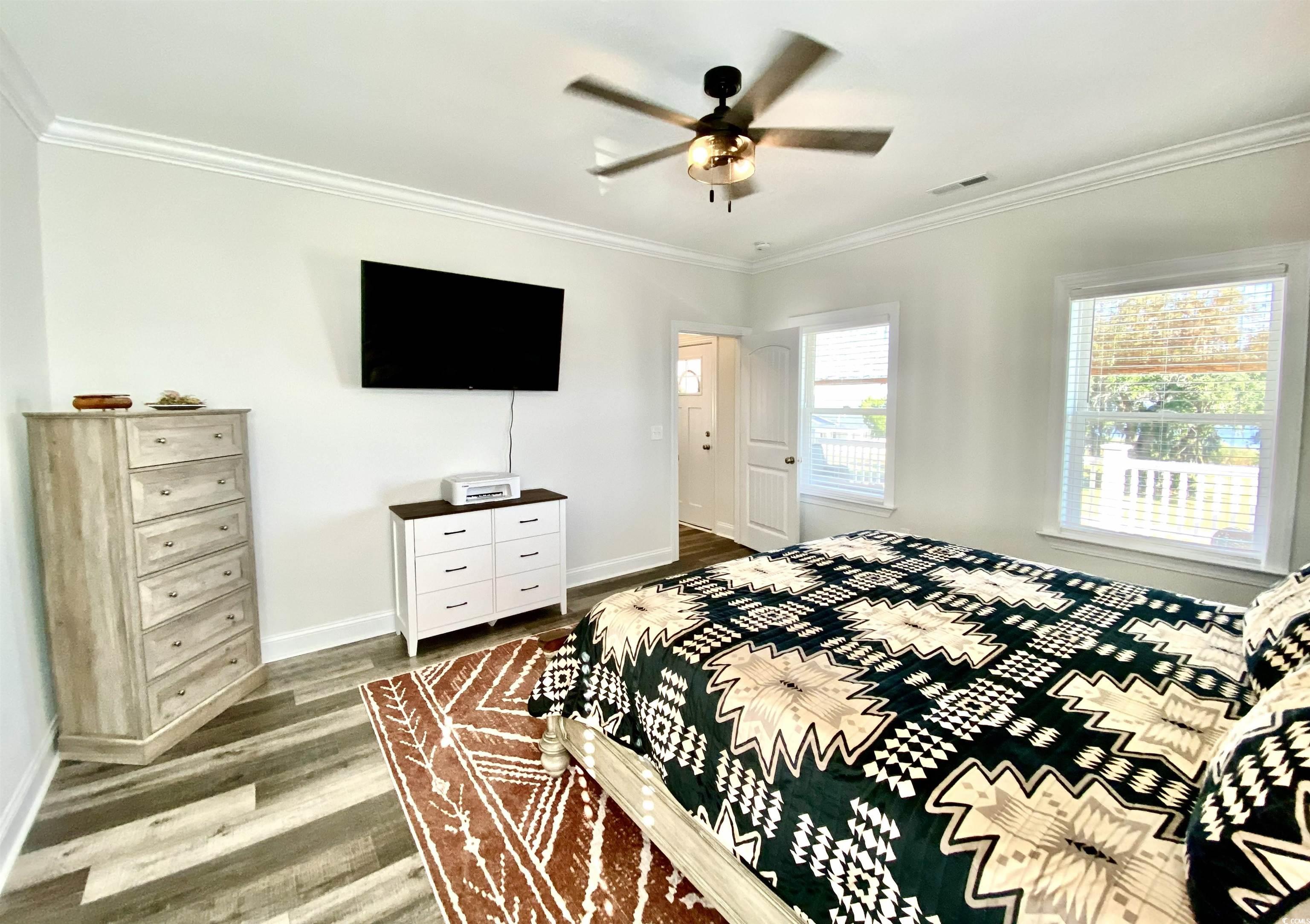 2664 Seaport Circle Georgetown, SC 29440 - Photo 18 of 40 Bedroom featuring crown molding, wood finished floors, and ceiling fan